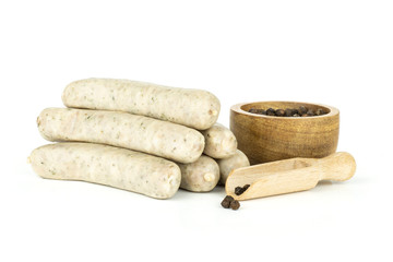 Group of six whole bavarian white sausage stack with black pepper in a wooden bowl isolated on white