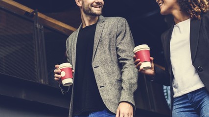 Couple having take away coffee together