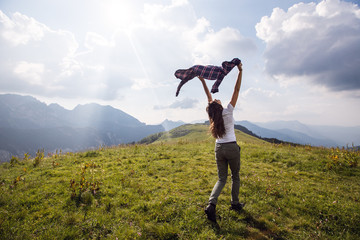 Tourist woman with raised hands outdoor.Freedom and travel concept