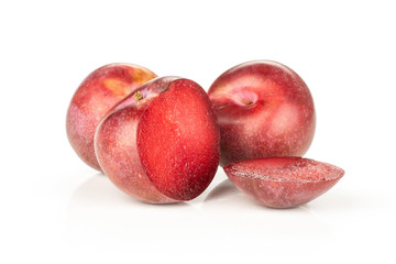Group of two whole two halves of fresh pluot interspecific plums variety one sliced isolated on white