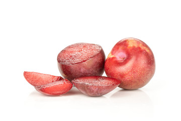 Group of one whole one half three slices of fresh pluot interspecific plums variety isolated on white
