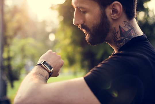 A man looking at his smartwatch