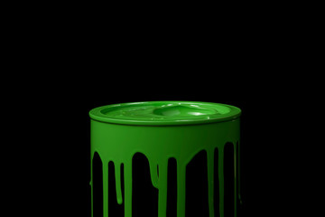 Green oil paint flowing over the wall of metal bucket. Isolated