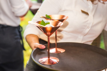 Close up Professional waiter in uniform with ice cream on a tray. Catering or celebration concept. Service at business, corporate meeting, party, weddings. Selective focus, space for text