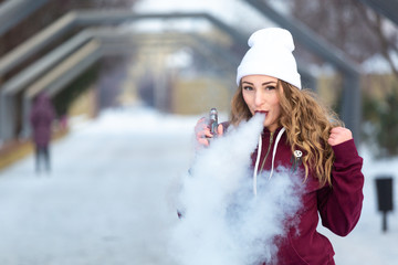 Young woman smoking electronic cigarette, young woman vaping. Vape