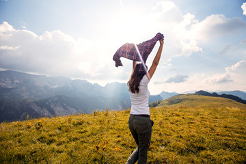 Fototapeta premium Tourist woman with raised hands outdoor.Freedom and travel concept