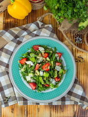 Salad with avocado and strawberry.