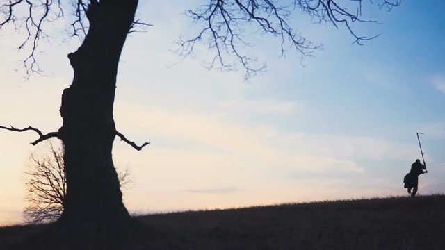 Grim Reaper sunset silhouette. concept of death. Soft focus
