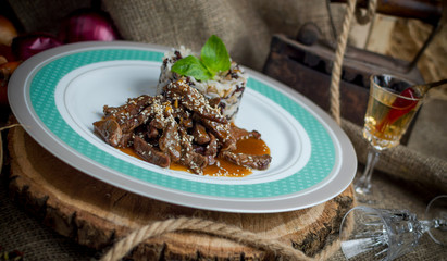 Meat piquant in sauce with rice