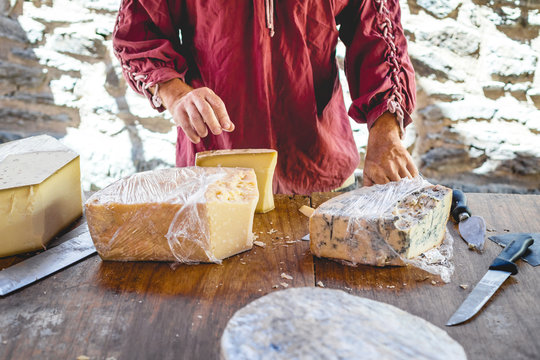Hand giving cheese for tasting