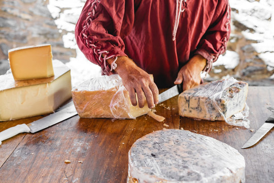 Hand giving cheese for tasting