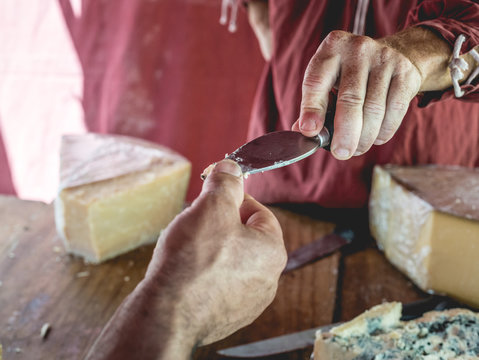Hand giving cheese for tasting
