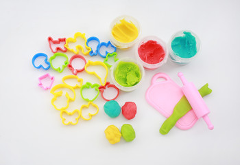 Colorful dough and rolling pin on white background for kid play to develop EQ and IQ.