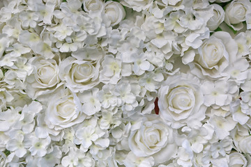 Artificial white rose and flowers background.
