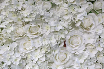 Abwaschbare Fototapete Artificial white rose and flowers background.   © zilvergolf