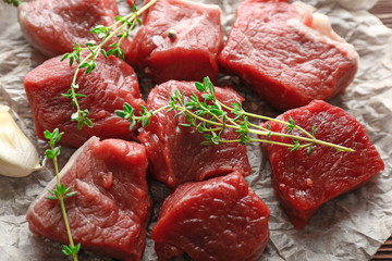 Pieces of raw meat with spices on table