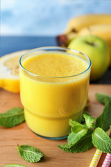 Glass of fresh tasty smoothie on table