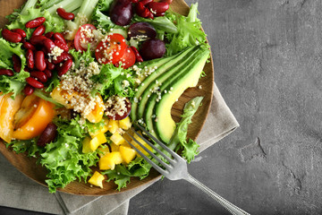 Plate with quinoa salad on grey background