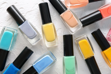 Obraz premium Bottles of colorful nail polishes on light table