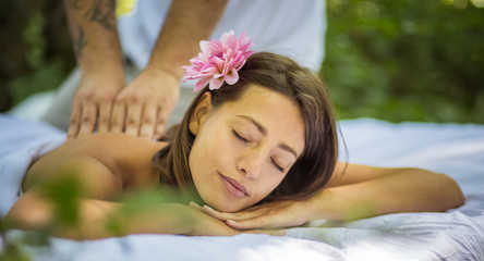 Close up image woman at massage treatment in nature.