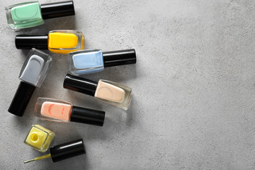 Bottles of colorful nail polishes on light table