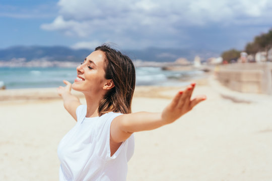 Smiling young woman enjoying the summer sun