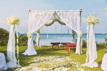 Beautiful beach wedding flower arch setting for wedding venue with panoramic ocean view