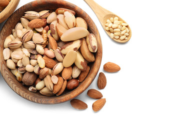 Bowl with different nuts on white background