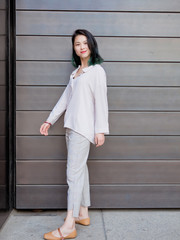 Fototapeta premium Beautiful young girl with green hair posing outdoor. Sunny portrait of glamour Chinese stylish lady. Emotions, people, beauty and lifestyle concept.
