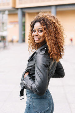 Street portrait of young smiling black woman