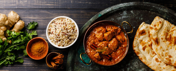 Chicken tikka masala spicy curry meat food with rice and naan bread on dark background - obrazy, fototapety, plakaty