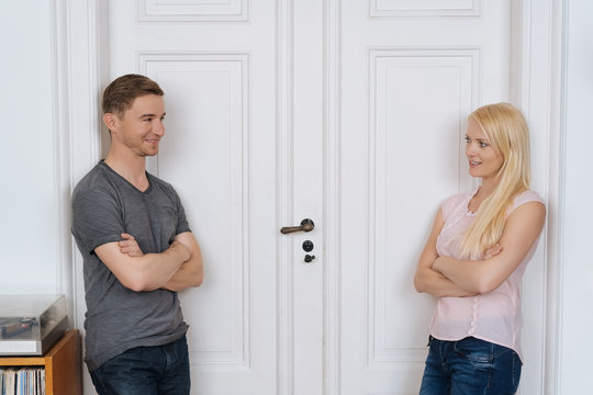 Couple in love waiting in front of a closed door