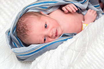 portrait of a newborn baby two days of life looking at the camera