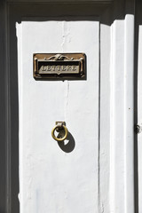 Mailbox on the white door.