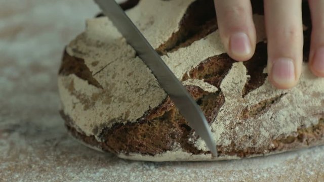 Slicing a loaf of rye bread