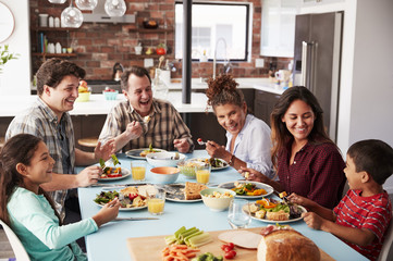 Multi Generation Family Enjoying Meal Around Table At Home Together - Powered by Adobe