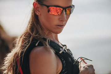 Sporty woman trail runner with sunglasses