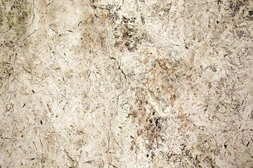 Vintage wall with scrapes, cracks  and scratches in tan.