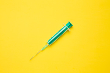 Medical syringe on colorful background.