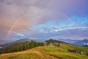 Mountain nature photo background with bright rainbow