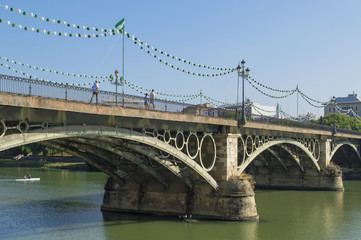 Fototapeta premium Puente de Isabel II con farolillos para la Velá de Santa Ana / Bridge of Isabel II with Chinese lanterns for the Velá of Holy Ana. Triana, Sevilla