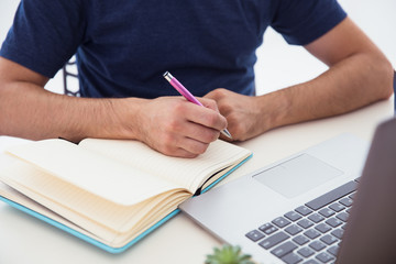 Student with paper notebook and pen in hands