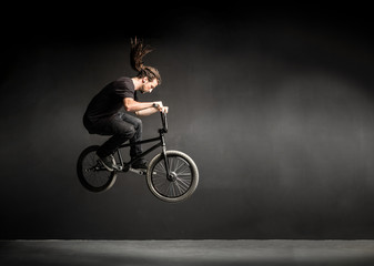 Young man doing a stunt on his BMX bicycle.