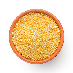 Fresh organic millet in bowl, Top view.