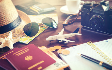 Travel accessories, passports, luggage, the cost of travel maps prepared for the trip on wooden...