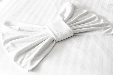 White bath towel on bed decoration in bedroom