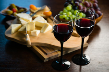 Two glasses of wine on the background of various appetizers