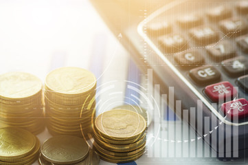stacked of coins with finance graph and calculator, concept as capital and investment