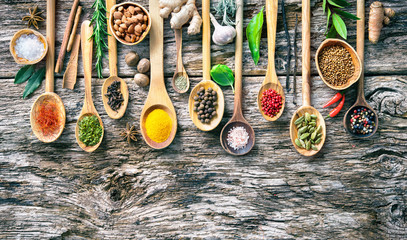 Various herbs and spices for cooking on old wooden board