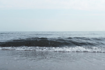Fototapeta na wymiar A beautiful sea with a wave off the coast. Photo of an amazing nature